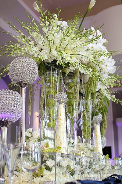 Crystal ball candle holders and tall vases full of flowers