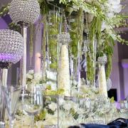 Crystal ball candle holders and tall vases full of flowers